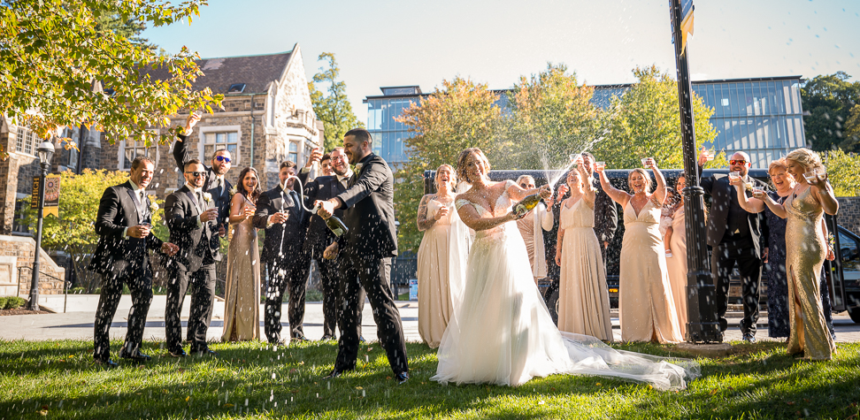 Emmaus Photographer Shows Wedding Party Popping Champagne On Summer Wedding Day